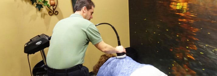 Chiropractor Oak Creek WI Daniel Hyatt doing an Ultrasound Treatment Chiropractor Oak Creek WI Daniel Hyatt doing an Ultrasound Treatment