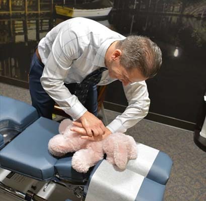 Chiropractor Oak Creek WI Daniel Hyatt Demonstrating Baby Adjustment