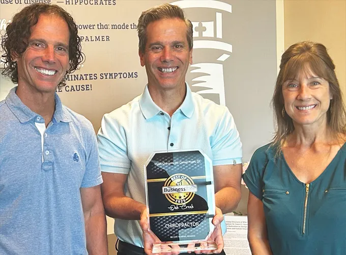 Chiropractor Oak Creek WI Daniel Hyatt With Team Holding Award