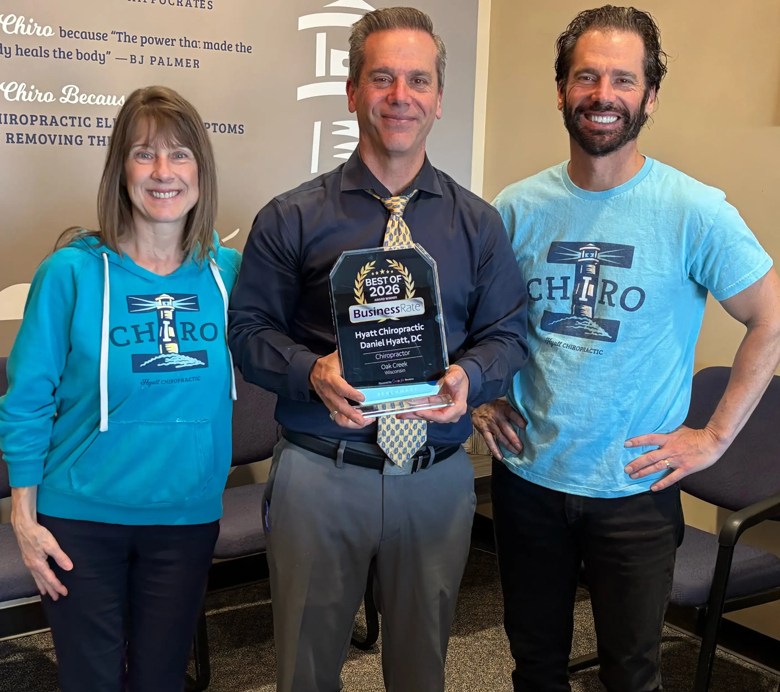 Chiropractor-Oak-Creek-WI-Daniel-Hyatt-With-Team-Holding-Award