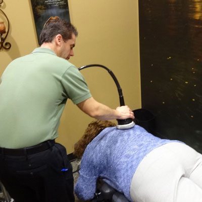 Chiropractor Oak Creek WI Daniel Hyatt doing an Ultrasound Treatment